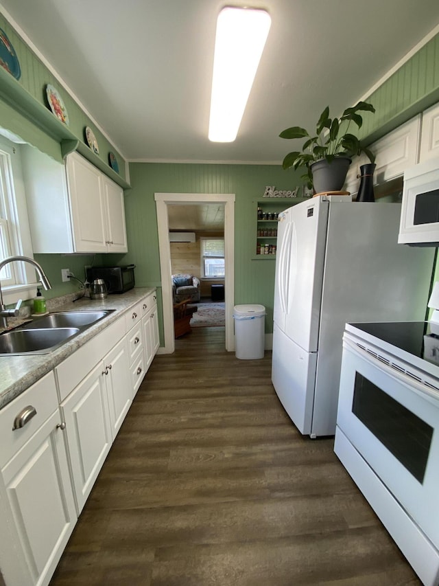 48 Dane Ave, Skowhegan, ME 04976 - kitchen with white appliances, white cabinetry, a wall mounted air conditioner, dark wood finished floors, and ornamental molding