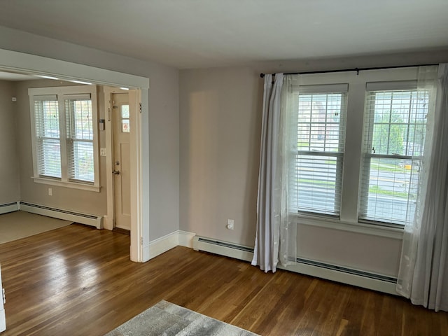 272 Center St, Bangor, ME 04401 - spare room featuring a baseboard heating unit, wood finished floors, and plenty of natural light