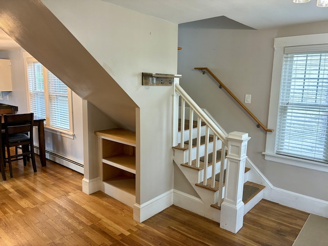 272 Center St, Bangor, ME 04401 - staircase with baseboard heating, wood finished floors, and plenty of natural light