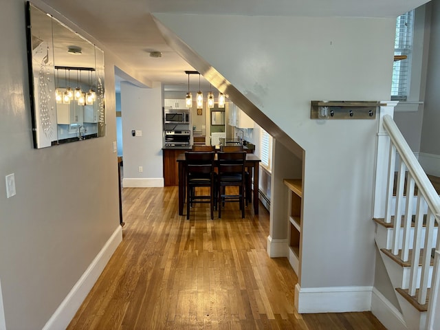 272 Center St, Bangor, ME 04401 - hall featuring wood finished floors, healthy amount of natural light, and stairs