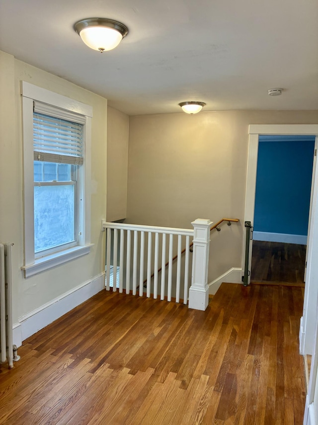 272 Center St, Bangor, ME 04401 - hallway with an upstairs landing, radiator, and wood finished floors