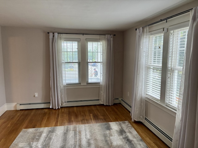 272 Center St, Bangor, ME 04401 - spare room with healthy amount of natural light, wood finished floors, and baseboard heating