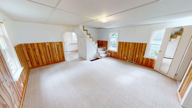 46 Crest Ave, Auburn, ME 04210 - basement with stairs, wainscoting, wooden walls, and carpet