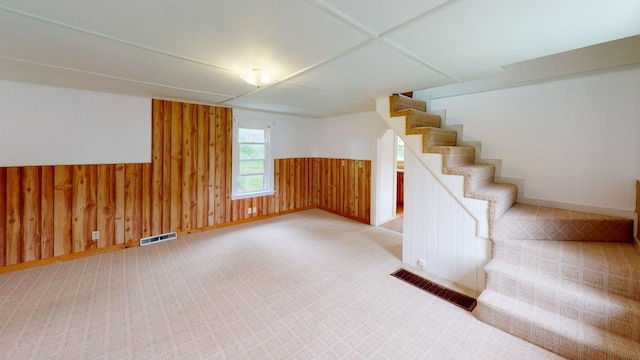 46 Crest Ave, Auburn, ME 04210 - basement featuring stairway, wooden walls, wainscoting, and light carpet