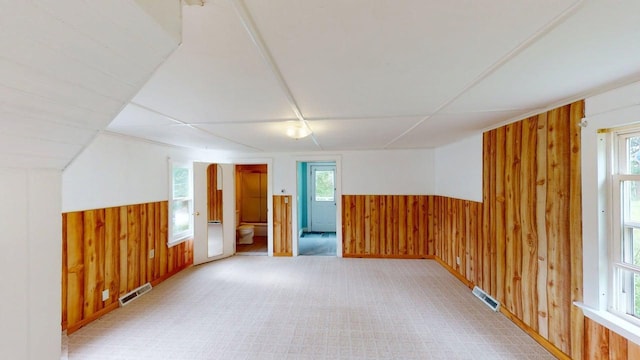 46 Crest Ave, Auburn, ME 04210 - unfurnished room featuring wooden walls, a wainscoted wall, and light carpet
