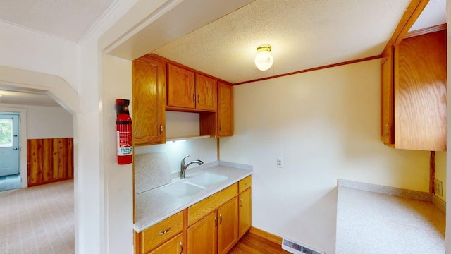 46 Crest Ave, Auburn, ME 04210 - kitchen with light countertops, brown cabinets, and light colored carpet