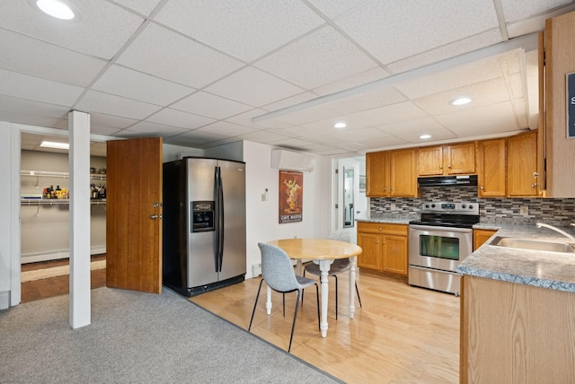 471 Methodist Rd, Westbrook, ME 04092 - kitchen featuring appliances with stainless steel finishes, under cabinet range hood, an AC wall unit, a drop ceiling, and backsplash