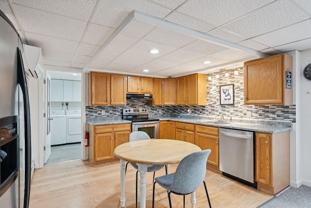 471 Methodist Rd, Westbrook, ME 04092 - kitchen with stainless steel appliances, washer and dryer, a paneled ceiling, tasteful backsplash, and under cabinet range hood