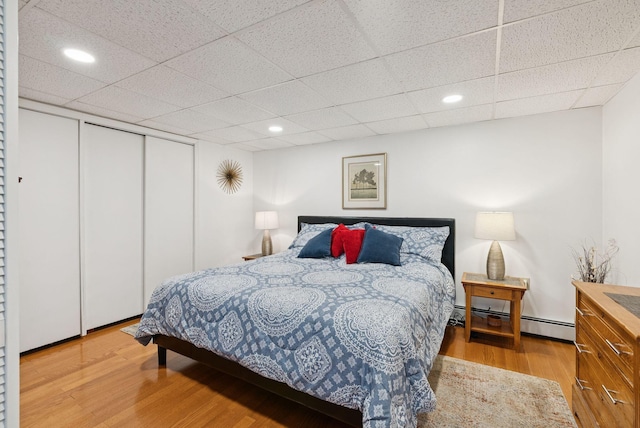 471 Methodist Rd, Westbrook, ME 04092 - bedroom featuring baseboard heating, wood finished floors, a drop ceiling, recessed lighting, and a closet