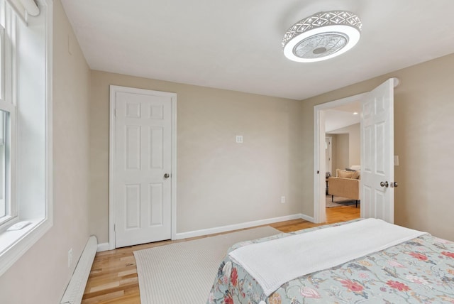 471 Methodist Rd, Westbrook, ME 04092 - bedroom featuring a baseboard heating unit and light wood-style floors