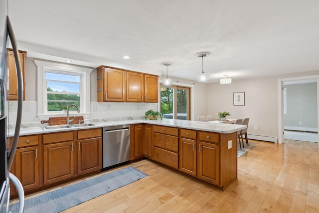 471 Methodist Rd, Westbrook, ME 04092 - kitchen featuring appliances with stainless steel finishes, a peninsula, brown cabinetry, a baseboard radiator, and light wood-style flooring