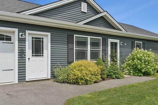 37 Homewood Blvd, Old Orchard Beach, ME 04064 - doorway to property featuring roof with shingles and an attached garage