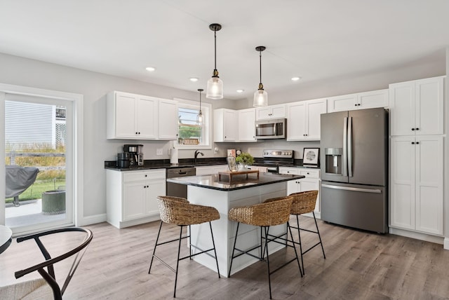 37 Homewood Blvd, Old Orchard Beach, ME 04064 - kitchen featuring stainless steel appliances, a breakfast bar area, white cabinets, dark countertops, and recessed lighting