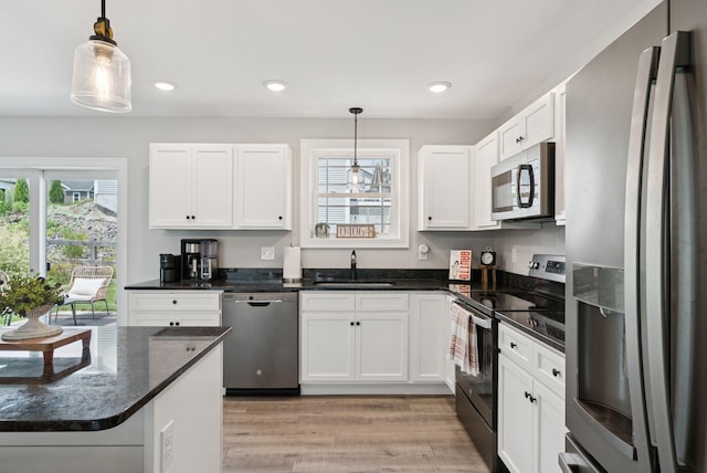 37 Homewood Blvd, Old Orchard Beach, ME 04064 - kitchen featuring appliances with stainless steel finishes, white cabinets, light wood finished floors, recessed lighting, and dark stone counters