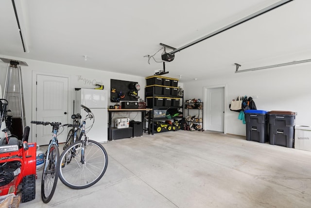 37 Homewood Blvd, Old Orchard Beach, ME 04064 - garage with freestanding refrigerator and a garage door opener