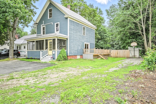 38 Silvermount St, Waterville, ME 04901 - back of house with a sunroom, a chimney, a deck, and a metal roof