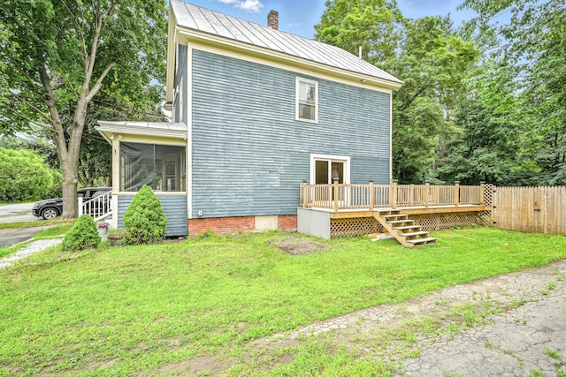 38 Silvermount St, Waterville, ME 04901 - back of house with a chimney, a standing seam roof, a wooden deck, a sunroom, and a metal roof