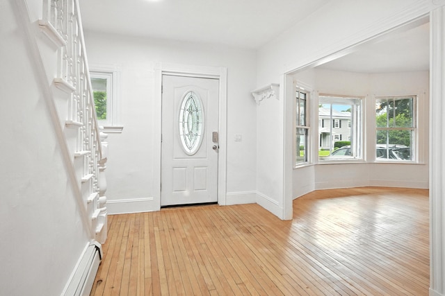 38 Silvermount St, Waterville, ME 04901 - foyer entrance featuring light wood-style flooring, healthy amount of natural light, and a baseboard radiator