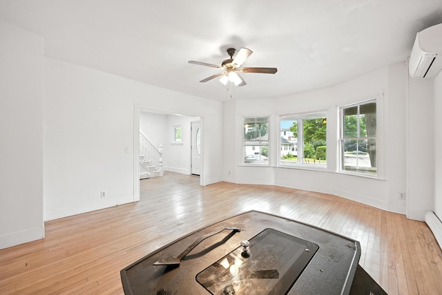 38 Silvermount St, Waterville, ME 04901 - unfurnished living room featuring hardwood / wood-style flooring, ceiling fan, stairway, and an AC wall unit