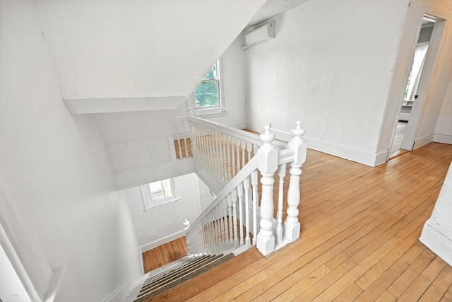 38 Silvermount St, Waterville, ME 04901 - staircase featuring a wall mounted AC and hardwood / wood-style flooring
