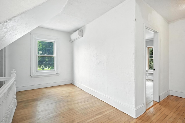 38 Silvermount St, Waterville, ME 04901 - additional living space with a wall unit AC, light wood-style flooring, and plenty of natural light