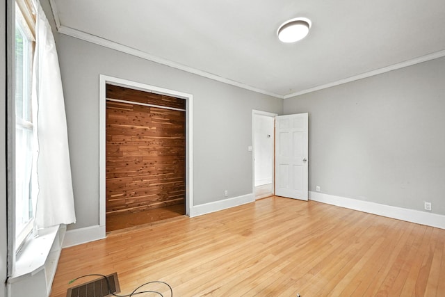38 Silvermount St, Waterville, ME 04901 - unfurnished bedroom featuring ornamental molding, light wood-type flooring, and a closet