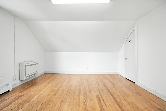 38 Silvermount St, Waterville, ME 04901 - bonus room with heating unit, vaulted ceiling, a baseboard radiator, light wood-style floors, and a skylight