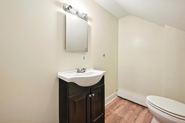 38 Silvermount St, Waterville, ME 04901 - bathroom featuring baseboard heating, vanity, vaulted ceiling, and wood finished floors