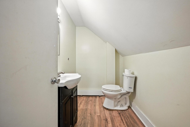 38 Silvermount St, Waterville, ME 04901 - half bath with lofted ceiling, wood finished floors, vanity, and a baseboard heating unit