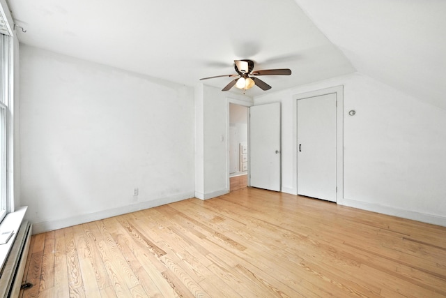 38 Silvermount St, Waterville, ME 04901 - unfurnished bedroom with a baseboard radiator, wood finished floors, a ceiling fan, and lofted ceiling