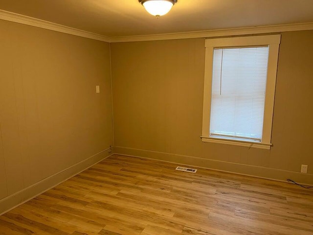 7 S Grove St, Waterville, ME 04901 - spare room featuring light wood finished floors, crown molding, and plenty of natural light