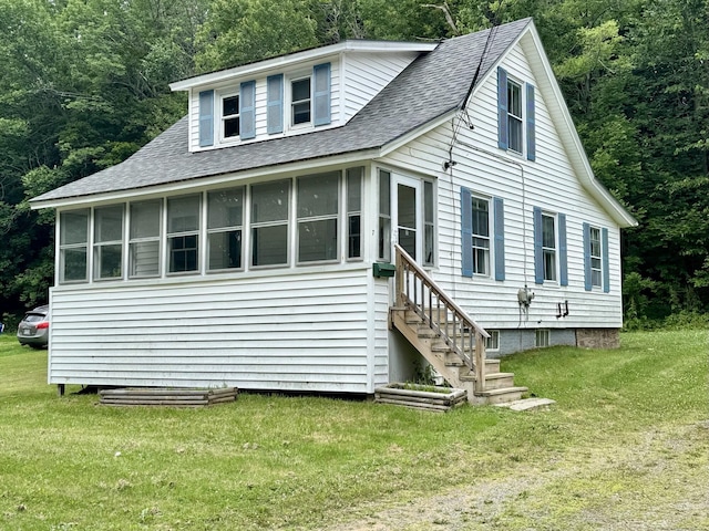 7 S Grove St, Waterville, ME 04901 - view of front of home with a shingled roof, a sunroom, a front lawn, and a forest view