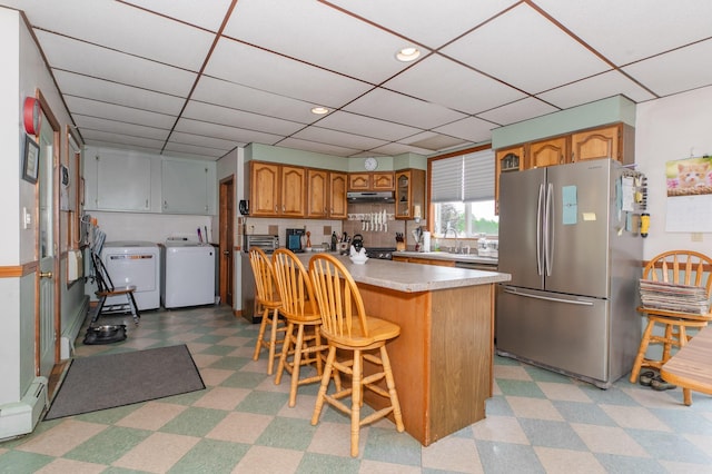 2887 Middle Rd, Sidney, ME 04330 - kitchen featuring freestanding refrigerator, independent washer and dryer, light flooring, light countertops, and a baseboard heating unit