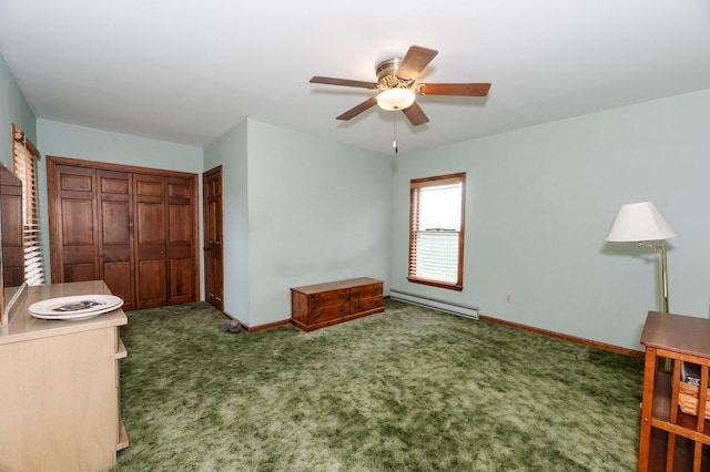 2887 Middle Rd, Sidney, ME 04330 - carpeted bedroom with a baseboard heating unit, a closet, and a ceiling fan