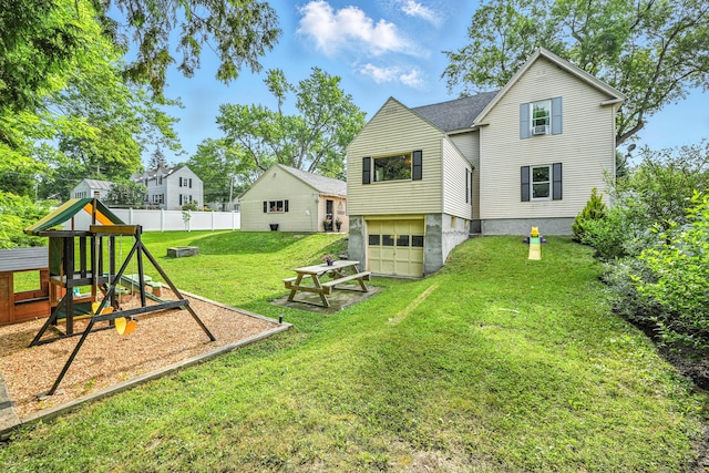 4 Hillcrest St, Waterville, ME 04901 - back of property with a garage, a playground, driveway, and roof with shingles