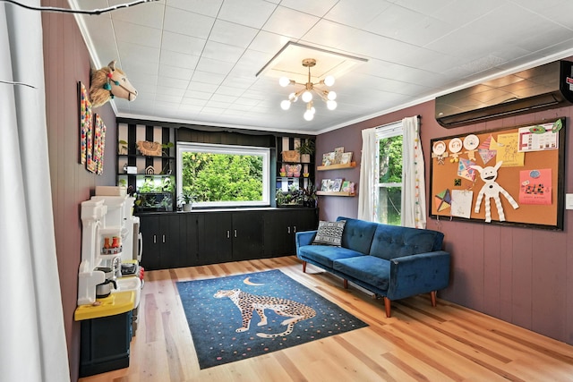 4 Hillcrest St, Waterville, ME 04901 - sitting room featuring healthy amount of natural light, wood finished floors, a wall mounted air conditioner, crown molding, and a chandelier