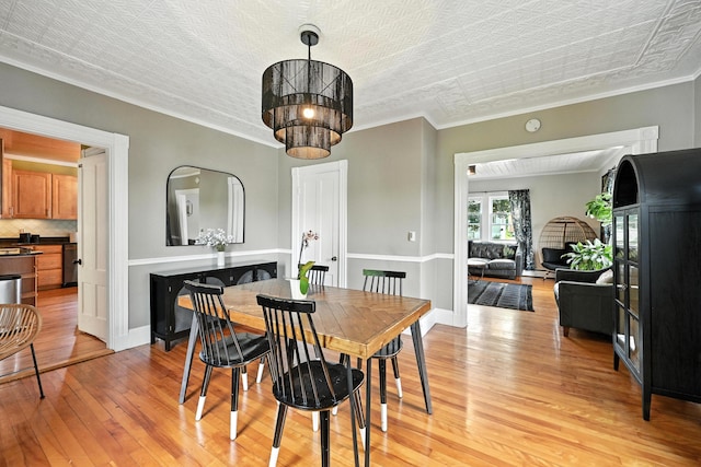 4 Hillcrest St, Waterville, ME 04901 - dining area with light wood-type flooring, an ornate ceiling, and crown molding