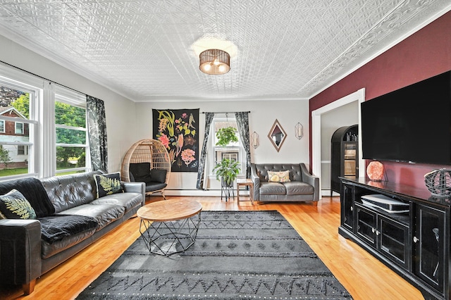 4 Hillcrest St, Waterville, ME 04901 - living room with an ornate ceiling, plenty of natural light, wood finished floors, ornamental molding, and a baseboard radiator