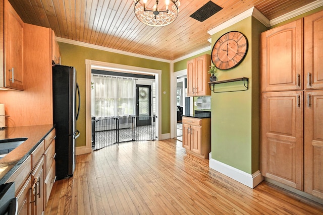 4 Hillcrest St, Waterville, ME 04901 - kitchen featuring freestanding refrigerator, ornamental molding, a chandelier, dark countertops, and light wood-type flooring