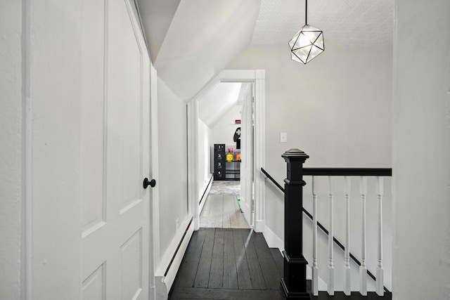 4 Hillcrest St, Waterville, ME 04901 - corridor featuring a baseboard heating unit, wood-type flooring, an upstairs landing, vaulted ceiling, and baseboard heating