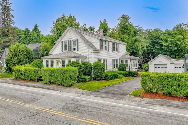 3 N Garand St, Winslow, ME 04901 - view of front facade with a chimney, an outdoor structure, a shingled roof, and a garage