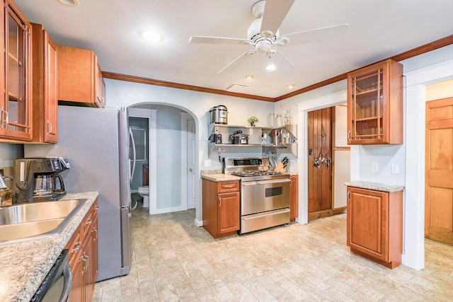 3 N Garand St, Winslow, ME 04901 - kitchen with stainless steel appliances, ceiling fan, arched walkways, ornamental molding, and brown cabinetry