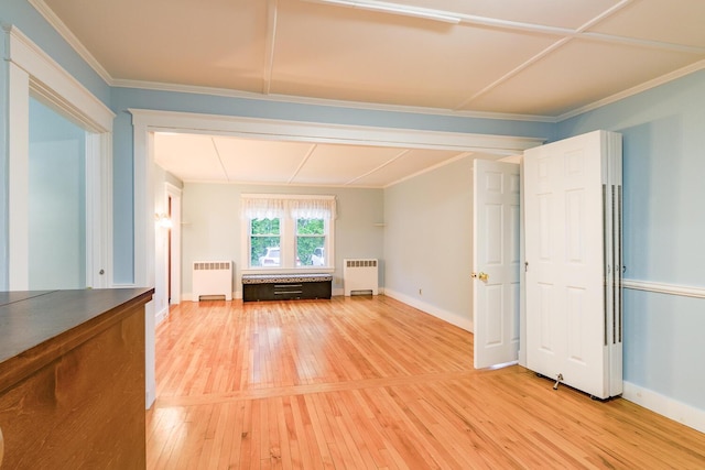 3 N Garand St, Winslow, ME 04901 - unfurnished living room with radiator heating unit, light wood finished floors, and ornamental molding