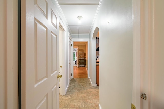 3 N Garand St, Winslow, ME 04901 - corridor featuring attic access, crown molding, light stone finish flooring, and arched walkways
