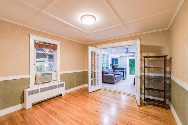 3 N Garand St, Winslow, ME 04901 - spare room with radiator, hardwood / wood-style flooring, cooling unit, french doors, and crown molding