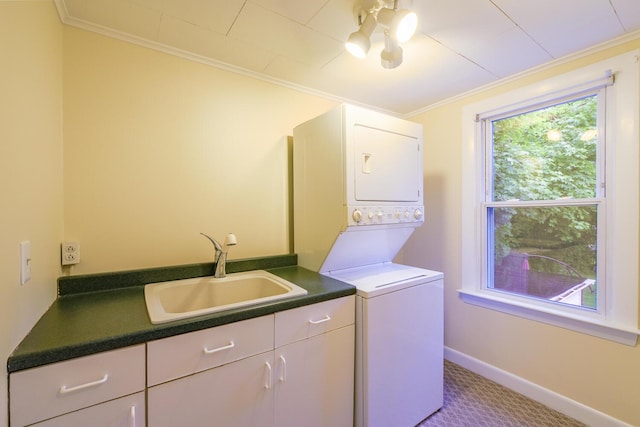 3 N Garand St, Winslow, ME 04901 - washroom featuring stacked washer and clothes dryer, crown molding, cabinet space, and carpet floors