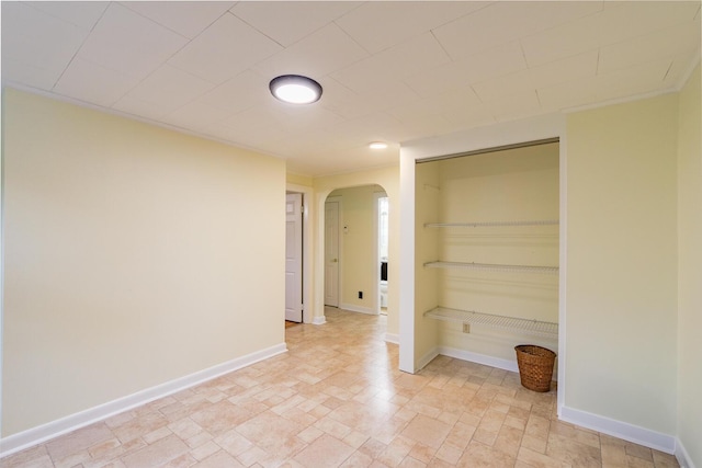 3 N Garand St, Winslow, ME 04901 - empty room featuring arched walkways and stone finish flooring