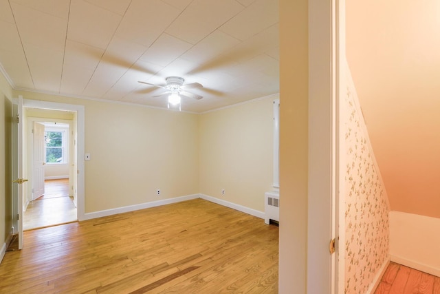 3 N Garand St, Winslow, ME 04901 - spare room with ornamental molding, light wood-style flooring, radiator heating unit, and a ceiling fan