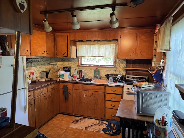 16 Glenwood Ave, Brewer, ME 04412 - kitchen featuring freestanding refrigerator, track lighting, and brown cabinetry