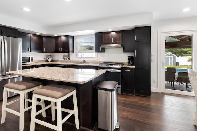 5 Fairview Ave, Auburn, ME 04210 - kitchen with stainless steel appliances, under cabinet range hood, a breakfast bar area, recessed lighting, and a center island